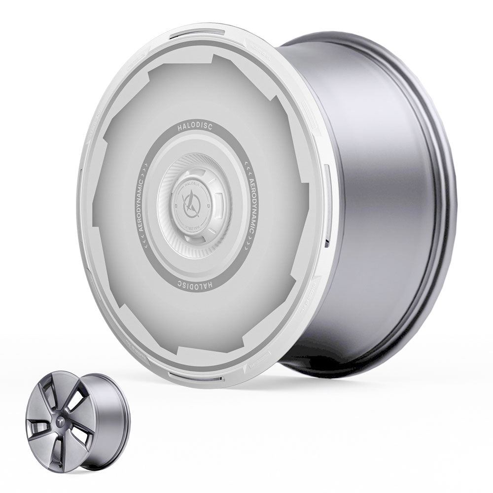 A large, futuristic silver HALODISC 2 Wheel Cover by HALOBLK Store for Tesla Model 3 2017-2023 18" Aero Wheels sits beside a smaller five-spoke alloy wheel for size comparison.