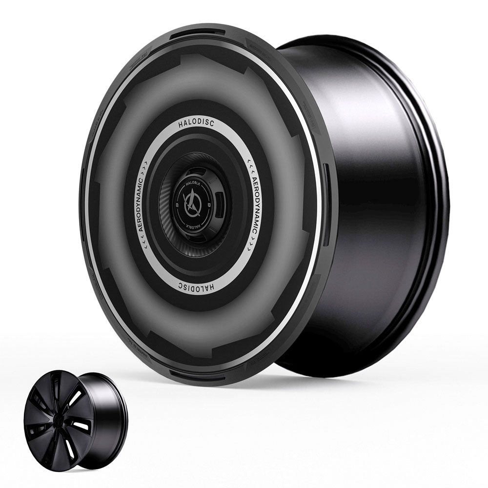 The HALODISC 2 Wheel Covers for Tesla Model 3 Highland 19" Nova Wheels by HALOBLK Store feature a matte black finish, aerodynamic grooves, and a sleek, modern design with a curved profile and minimalist appearance.