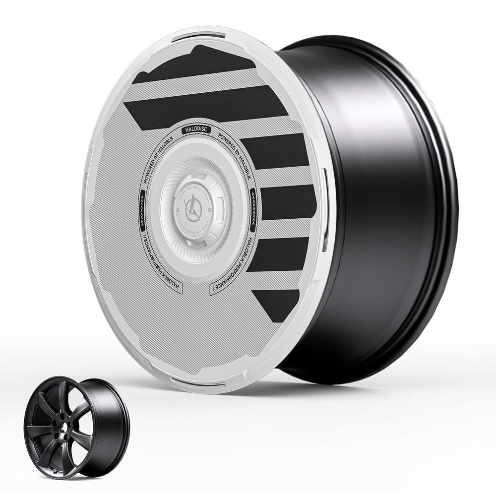 The HALODISC 2 Wheel Covers for Tesla Model 3 (2017-2018) by HALOBLK Store feature a black rim with a modern white aerodynamic cover, accented by black stripes and center text; a smaller plain black rim is displayed in the lower left for comparison.