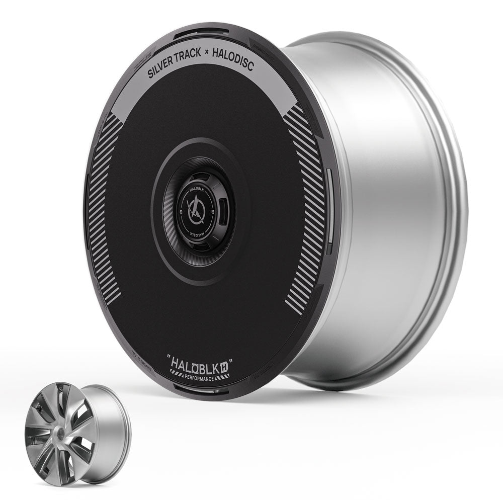 A large silver Tesla Model 3 wheel with a HALODISC 2 cover (Silver Track, HALOBLK Store) stands upright beside a smaller uncovered silver rim.
