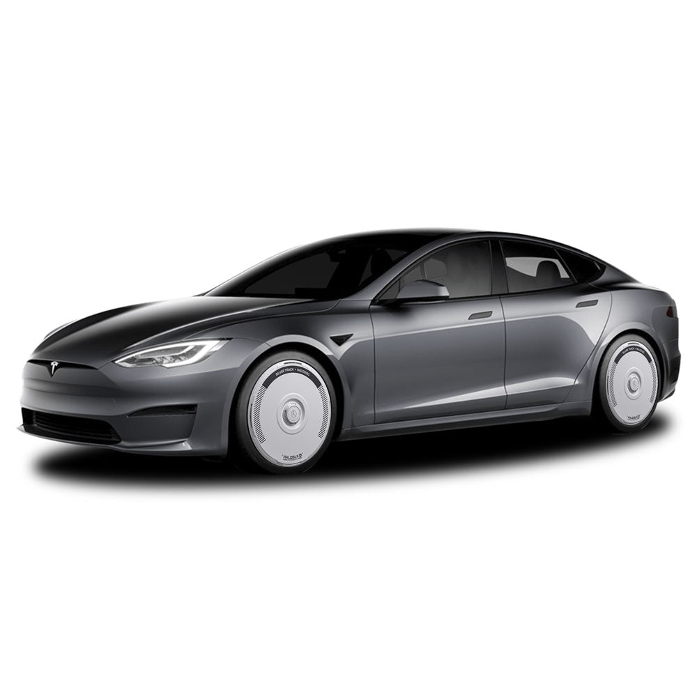 A silver Tesla Model S with HALODISC 2 Wheel Covers for 21" Arachnid Wheels by HALOBLK Store is seen from the front left, highlighting its sleek design and distinctive HALODISC Silver Track covers, set against a white background.