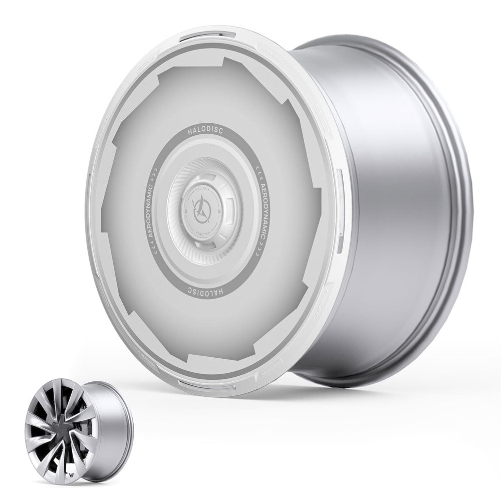 The HALODISC 2 Wheel Covers by HALOBLK Store for Tesla Model Y Juniper 20" Helix 2.0 Wheels feature a sleek, silver, futuristic design with a smooth center, shown next to a standard wheel for comparison against a white background.