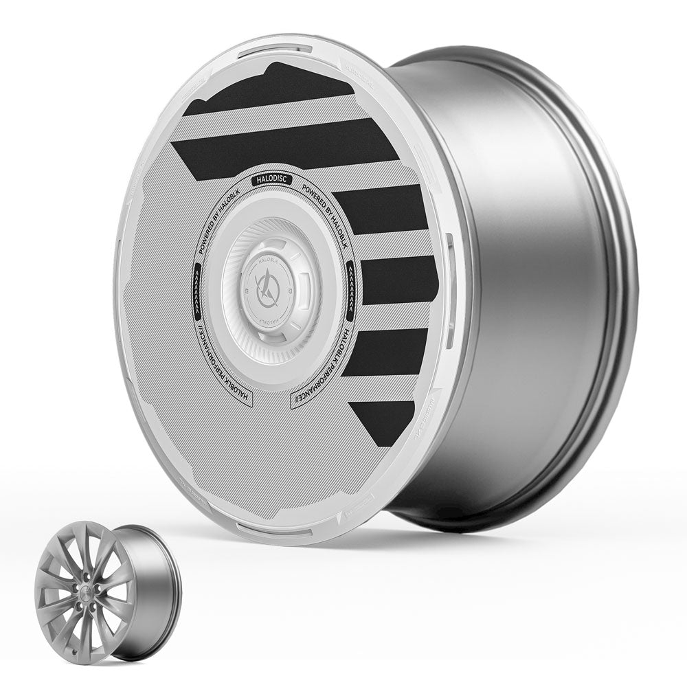 The HALODISC 2 Wheel Covers for Tesla Model S 19" Slipstream Wheels by HALOBLK Store feature a modern silver and black aerodynamic disc cover, shown next to a traditional open-spoke rim for comparison.