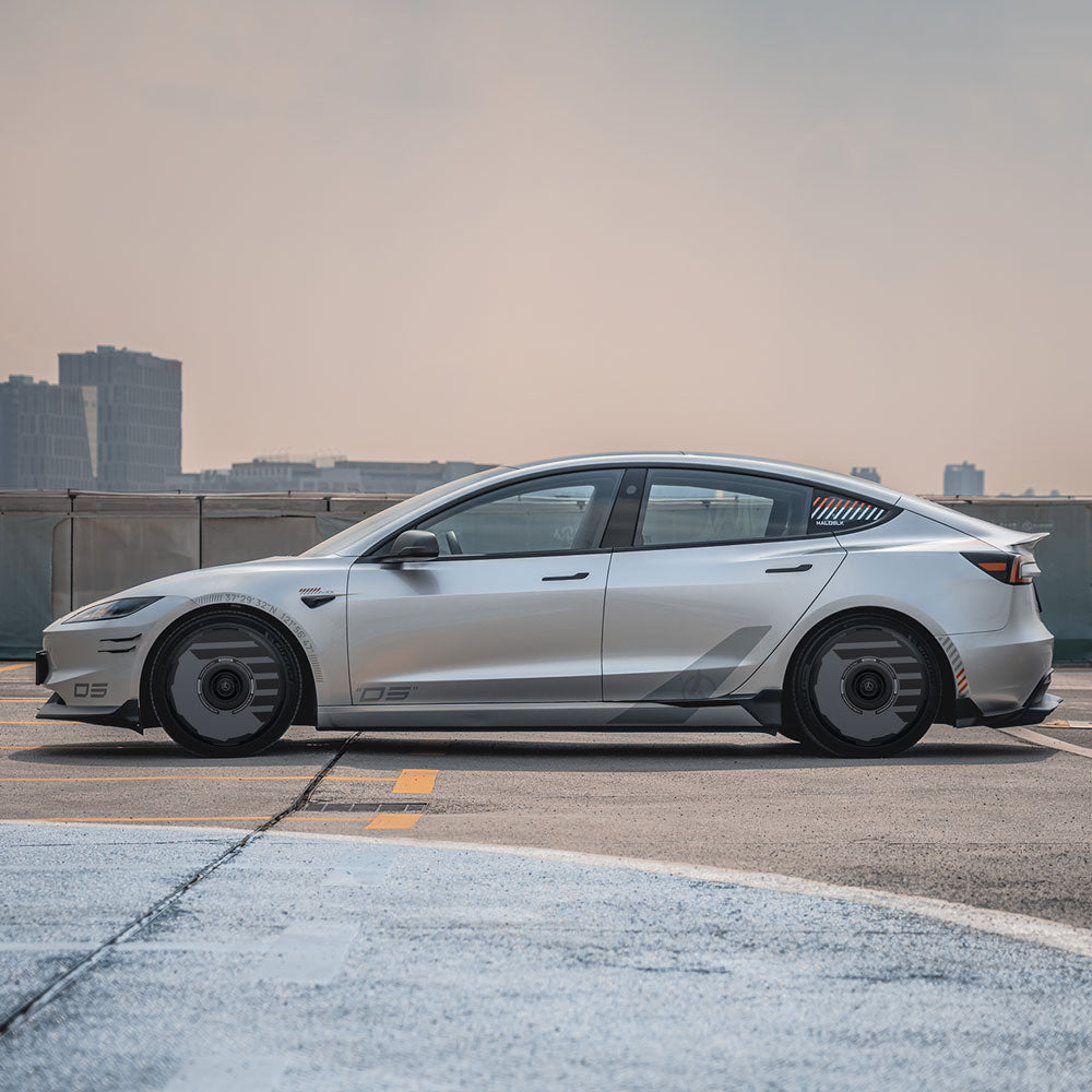 A Tesla Model 3 Highland with 18" Photon Wheels is equipped with HALODISC 2 Wheel Covers from HALOBLK Store, parked on a rooftop overlooking a city skyline under a hazy sky, showcasing a modern and sleek design.