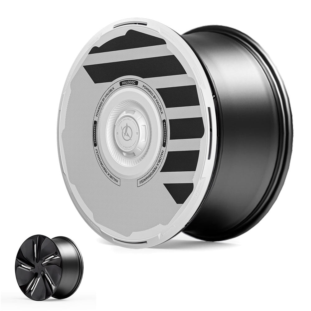 A close-up of HALODISC 2 Wheel Covers for Tesla Model Y Juniper 19" Crossflow Wheels by HALOBLK Store, featuring a modern black and white geometric design with circular patterns and contrasting stripes. A smaller rim image appears in the corner.