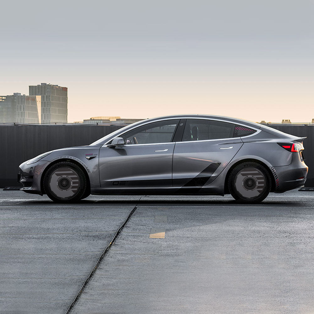 A Tesla Model 3 (2021-2023) with HALODISC 2 Wheel Covers from HALOBLK Store is parked on a rooftop against a cityscape at dusk, featuring tinted windows and sleek black detailing on its sides.