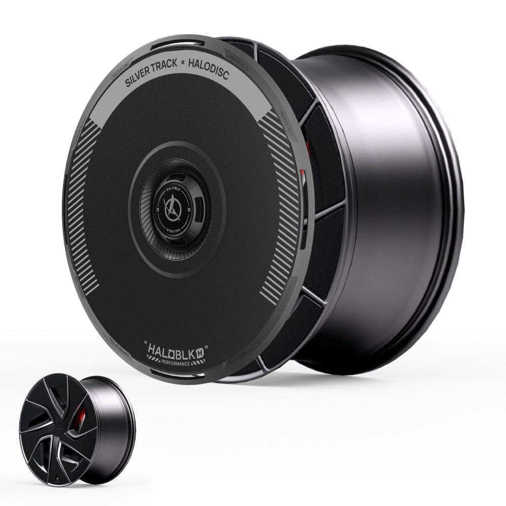 A sleek set of black HALODISC 2 Wheel Covers by HALOBLK Store for Tesla Model S 19" Magnetite Wheels features a disc-like Silver Track design on the larger wheel and a five-spoke pattern on the smaller wheel.