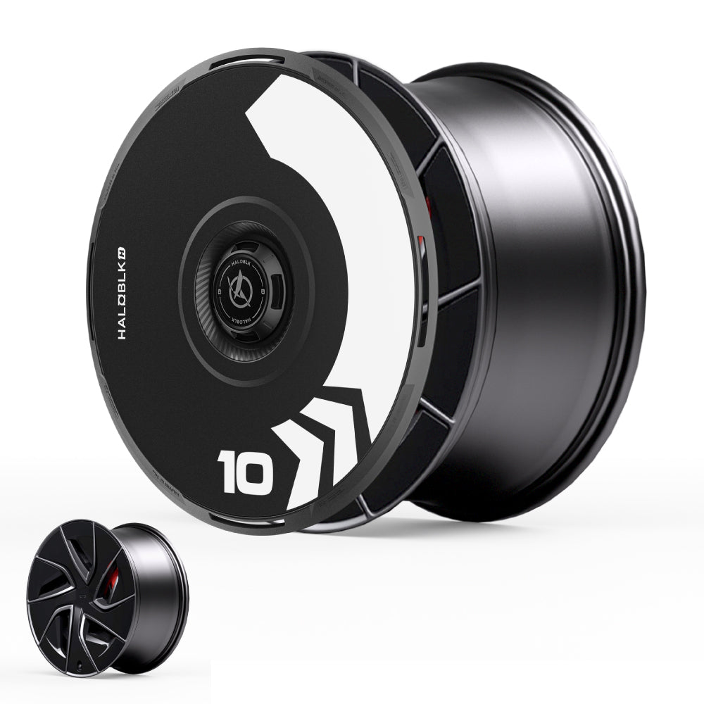 The HALODISC 2 Wheel Covers for Tesla Model S 19" Magnetite Wheels by HALOBLK Store feature a bold black and white geometric arrow design with the number 10. A smaller rim with a different pattern appears in the lower left, both offering sleek, modern style.