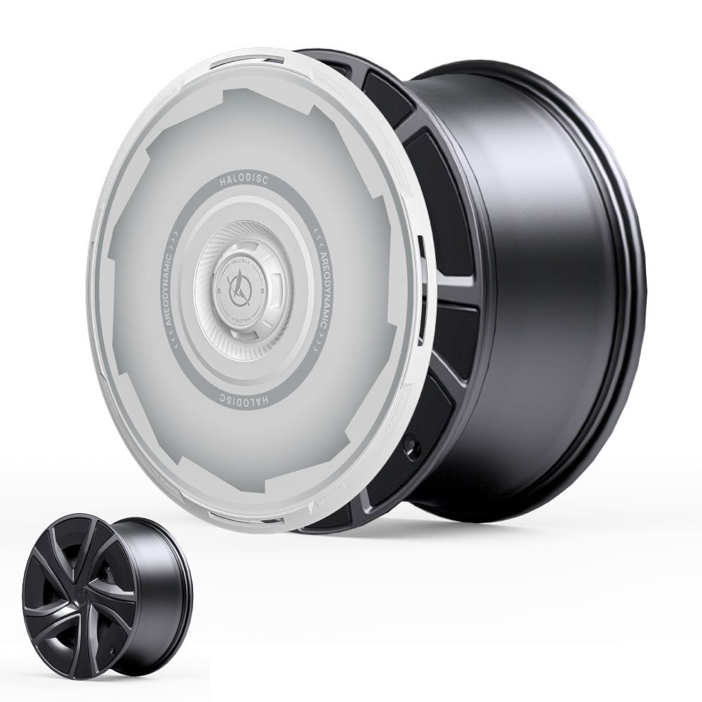 The HALODISC 2 Wheel Covers for Tesla Model X 2021-2025 20" Perihelix Wheels by HALOBLK Store are shown: a large, sleek black wheel with a futuristic translucent white center cover, plus a smaller uncovered wheel for comparison.