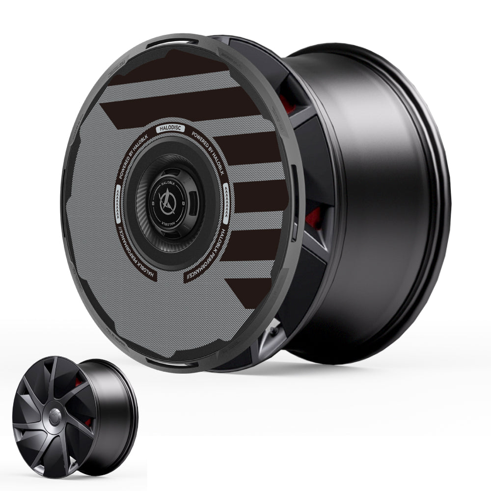 The HALODISC 2 Wheel Covers for Tesla Model S 21" Velarium Wheels by HALOBLK Store feature a modern, futuristic black design with angular geometric patterns and metallic gray accents, displayed from two angles on a white background.