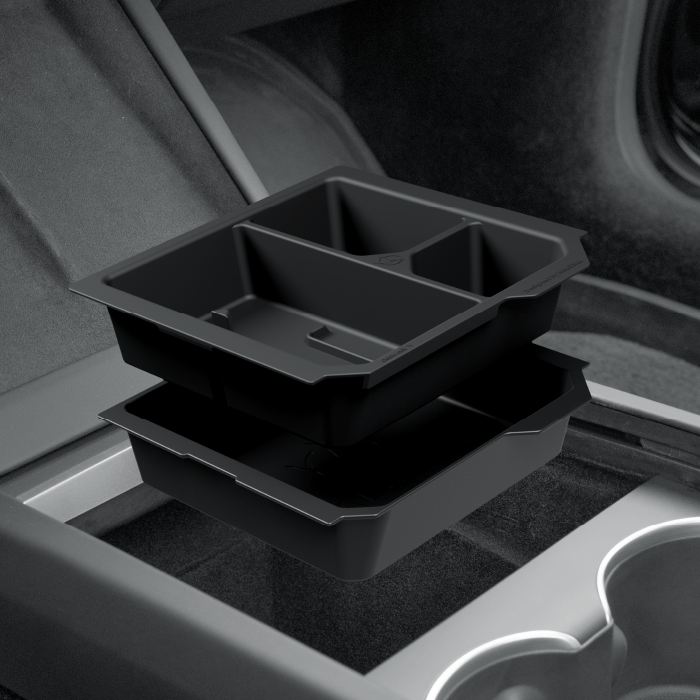 Two Center Console Organizer-Armrest Storage Boxes for Model 3 Highland by HALOBLK Store are stacked in a car’s center console, featuring divided compartments for small items, with the interior and cup holders visible.