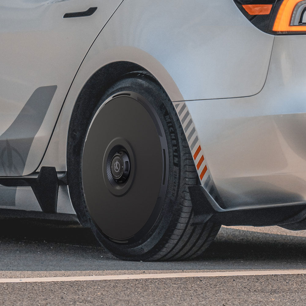 A close-up of a Tesla Model 3 Highland fitted with HALODISC 2 Wheel Covers from HALOBLK Store on its 18" Photon wheels shows the sleek black aerodynamic cover and visible Michelin tire on asphalt.