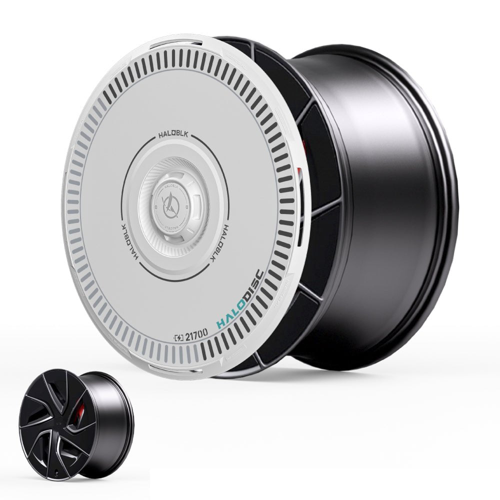 The image shows HALODISC 2 Wheel Covers for Tesla Model S 19" Magnetite Wheels by HALOBLK Store, featuring a black and white cylindrical design with a circular white faceplate and gray and green accents; a smaller version is in the corner.