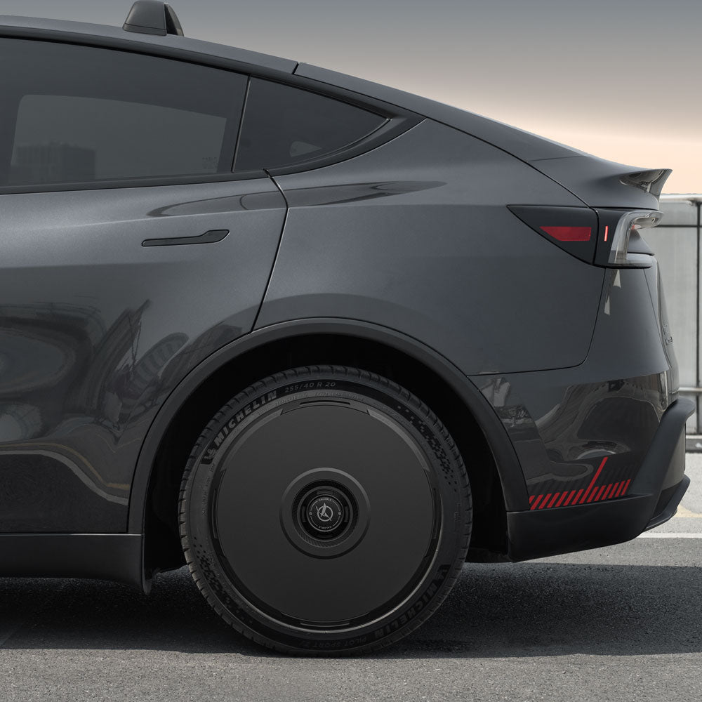 Side view of the rear half of a dark gray Tesla Model Y with HALOBLK Store HALODISC 2 Wheel Covers for Juniper 20" Helix 2.0 wheels, featuring a large, solid black aerodynamic rear wheel cover.