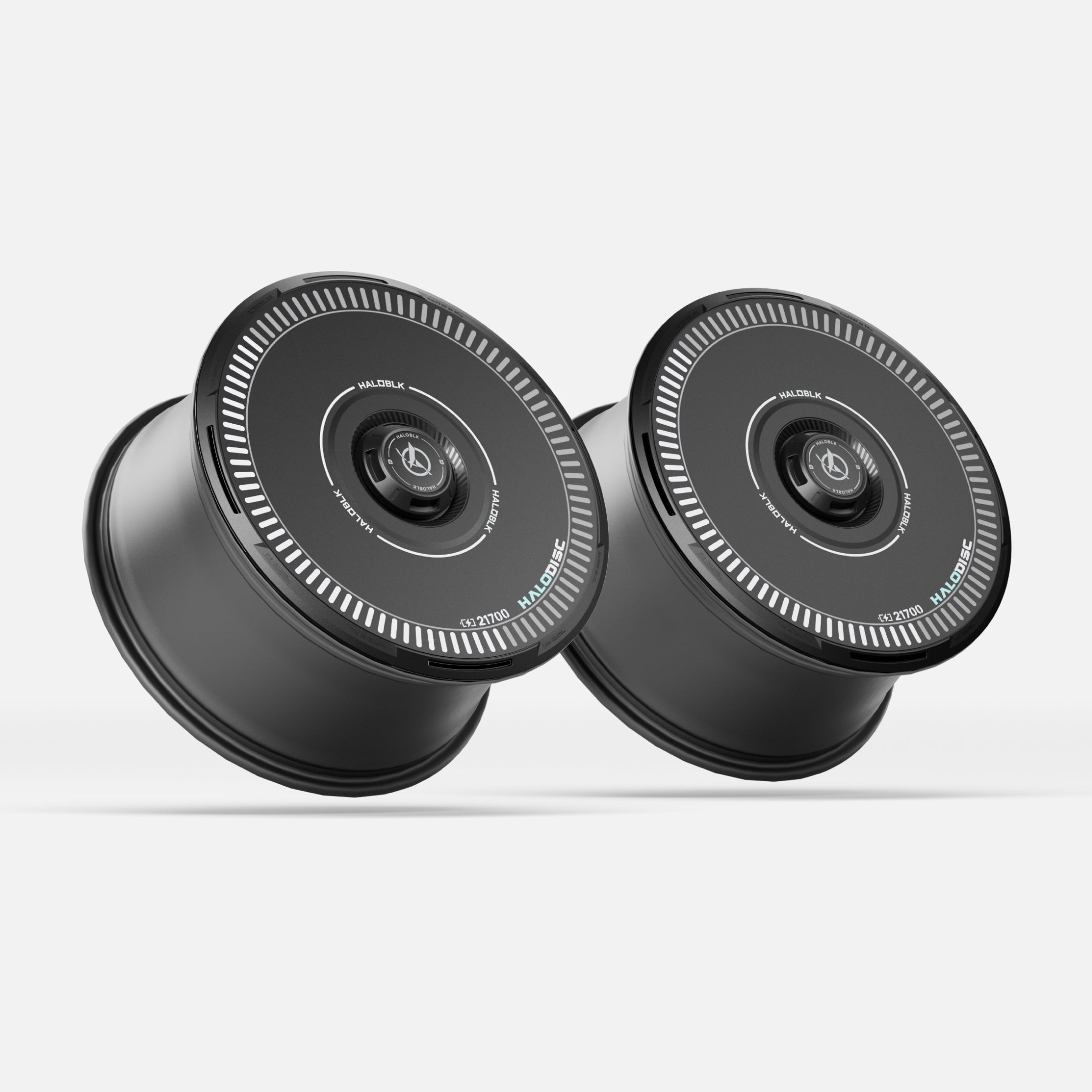 Two black HALODISC 2 Wheel Covers for Tesla Model 3 by HALOBLK Store, featuring circular control panels and white markings on top, are placed side by side on a plain white background.