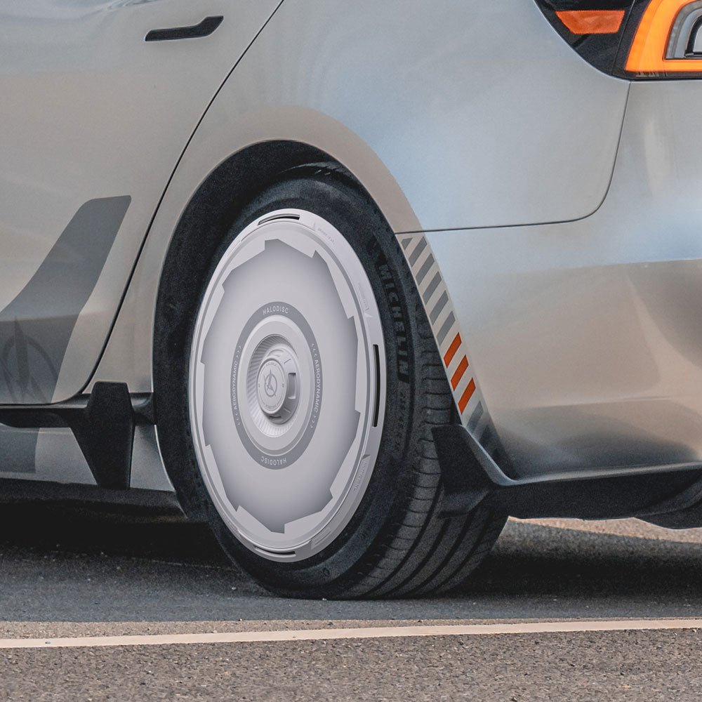 Close-up of a Tesla Model 3 Highland with HALODISC 2 Wheel Covers by HALOBLK Store on 20" Warp Wheels, featuring a futuristic, streamlined design and visible Michelin tire branding.