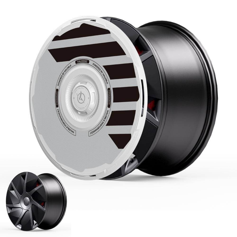 The HALODISC 2 Wheel Covers for Tesla Model S 21" Velarium Wheels by HALOBLK Store feature a bold, futuristic black rim with a large white and gray circular cover with striking black stripes and center text. A plain black rim is shown in the bottom left for comparison.
